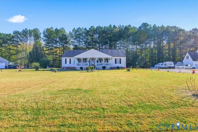 a aerial view of a house with swimming pool and a yard