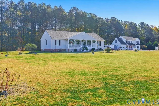 a view of house with swimming pool outdoor seating and yard