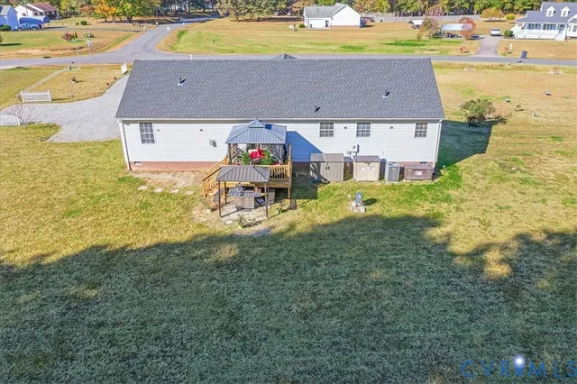 a aerial view of a house with garden space and trees