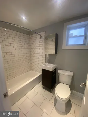a bathroom with a toilet a sink and bathtub