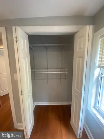 a view of closet with wooden floor