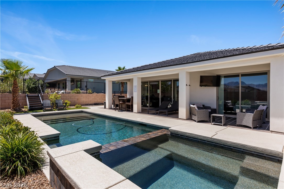 1436 Manassas Ridge Mesquite, NV 89027 - Photo 54 of 77 Lounge poolside in your backyard oasis with covered patios and mountain views.