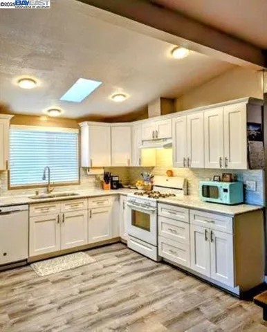 a large kitchen with cabinets and wooden floor