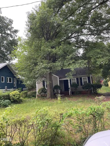 front view of a house with a yard table and chairs