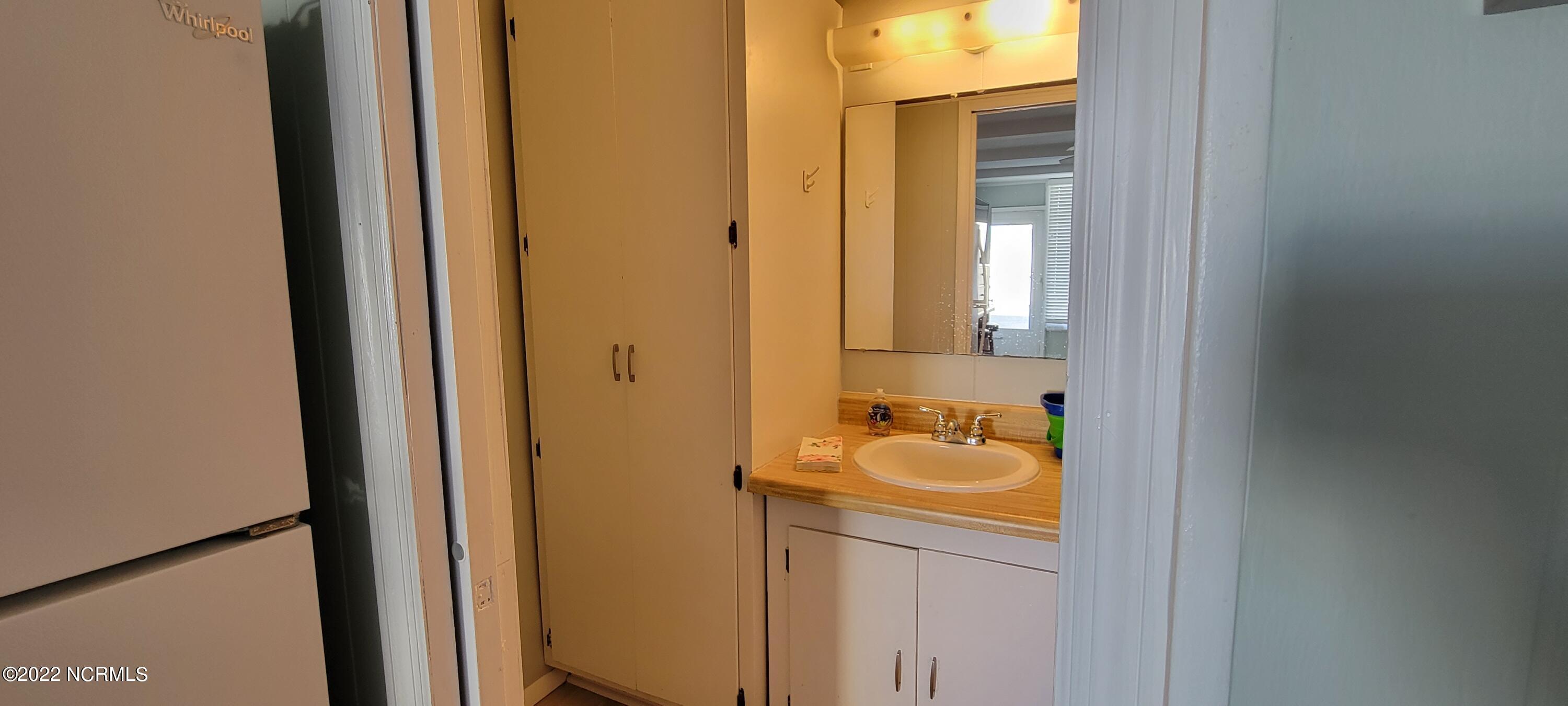 2401 West Fort Macon Road, Unit 119 Atlantic Beach, NC 28512 - Photo 6 of 21 Wardrobe and bathroom sink