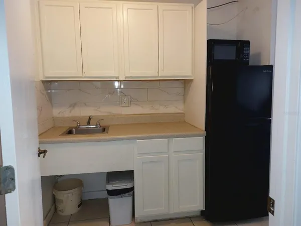 a kitchen with a sink and cabinets
