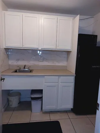 a kitchen with stainless steel appliances white cabinets and a sink
