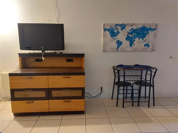 a room with a furniture and a flat screen tv