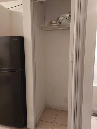 a view of a refrigerator in kitchen