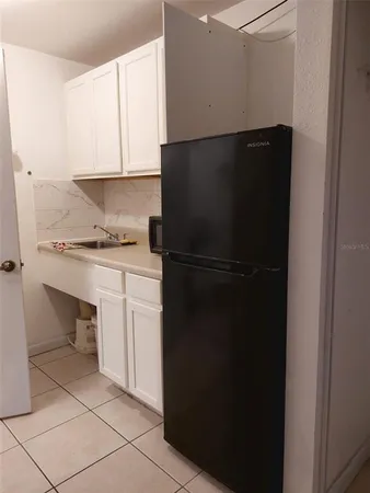 a kitchen with a refrigerator and cabinets