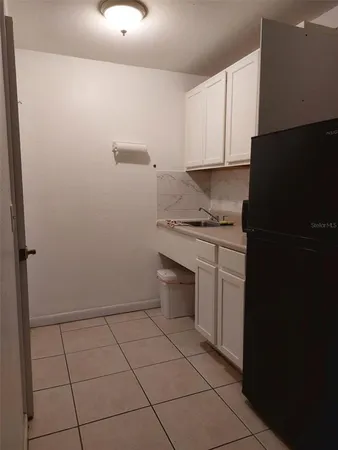 a kitchen with a sink toilet and cabinets