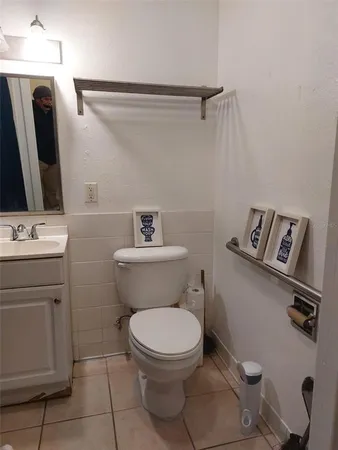 a white toilet sitting next to a bathroom sink