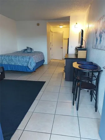 a bedroom with a bed and a mirror in it