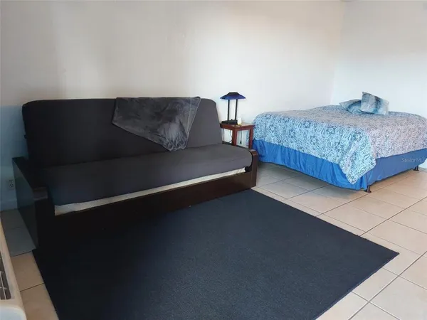 a bedroom with bed and window