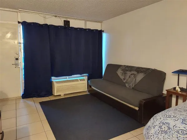 a living room with a couch and a dresser