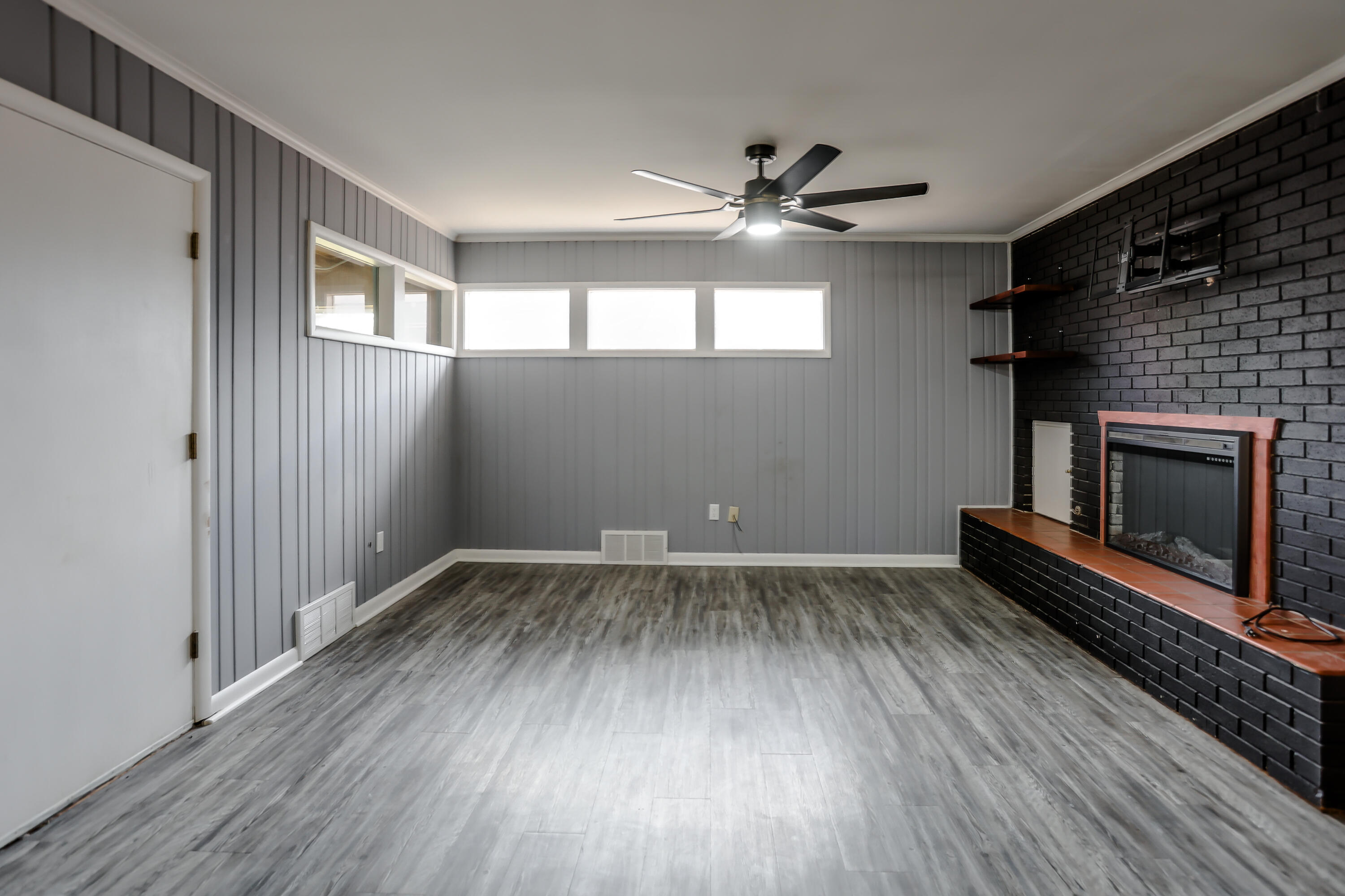 3615 47th Street Lubbock, TX 79413 - Photo 10 of 36 wooden floor in an empty room with a fireplace