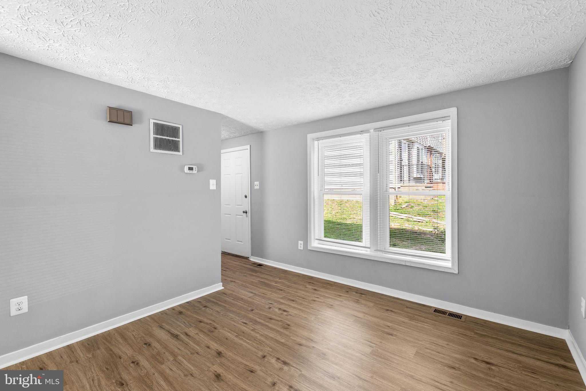 9479 Inaugural Drive King George, VA 22485 - Photo 6 of 26 an empty room with wooden floor and windows