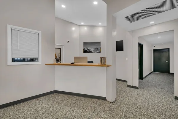 a view of kitchen with stainless steel appliances kitchen island sink and refrigerator