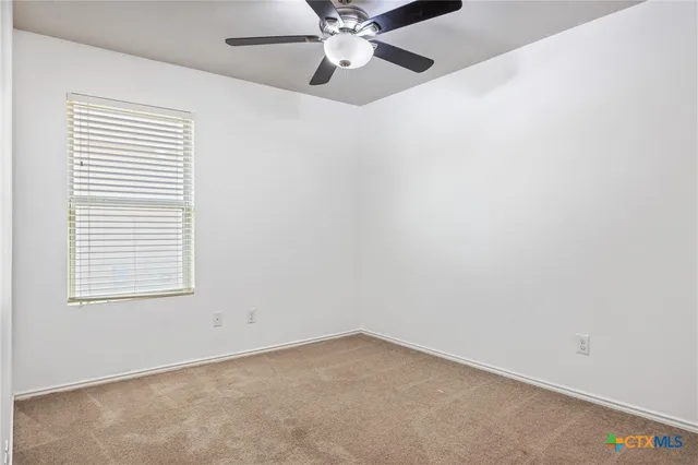 an empty room with ceiling fan