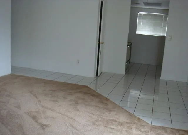 a view of empty room with a fireplace