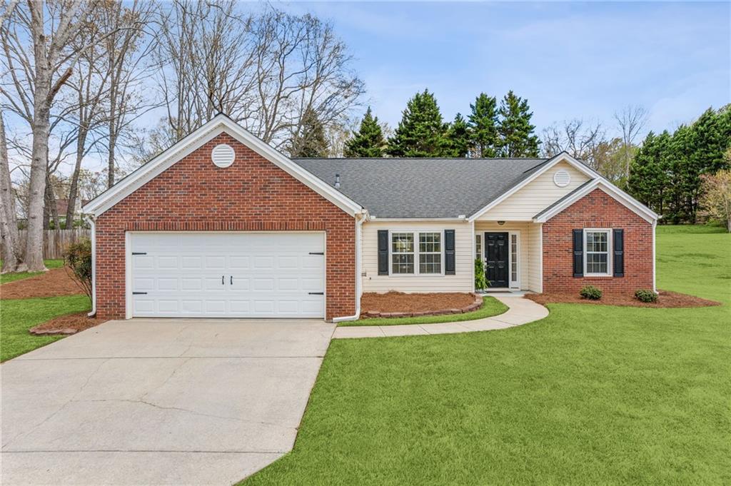 4260 Ridgebrook Bend Cumming, GA 30028 - Photo 1 of 1 a front view of a house with a yard and garage