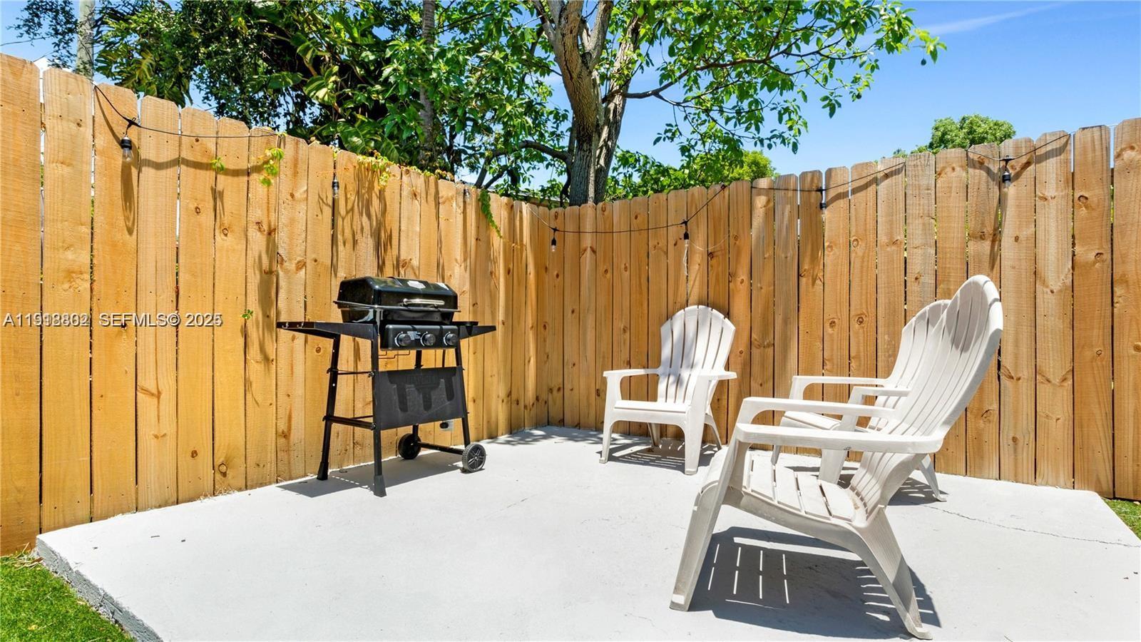 32 Southwest 9th Street, Unit 3 Hallandale Beach, FL 33009 - Photo 12 of 13 a view of a swimming pool with a chair and potted plants