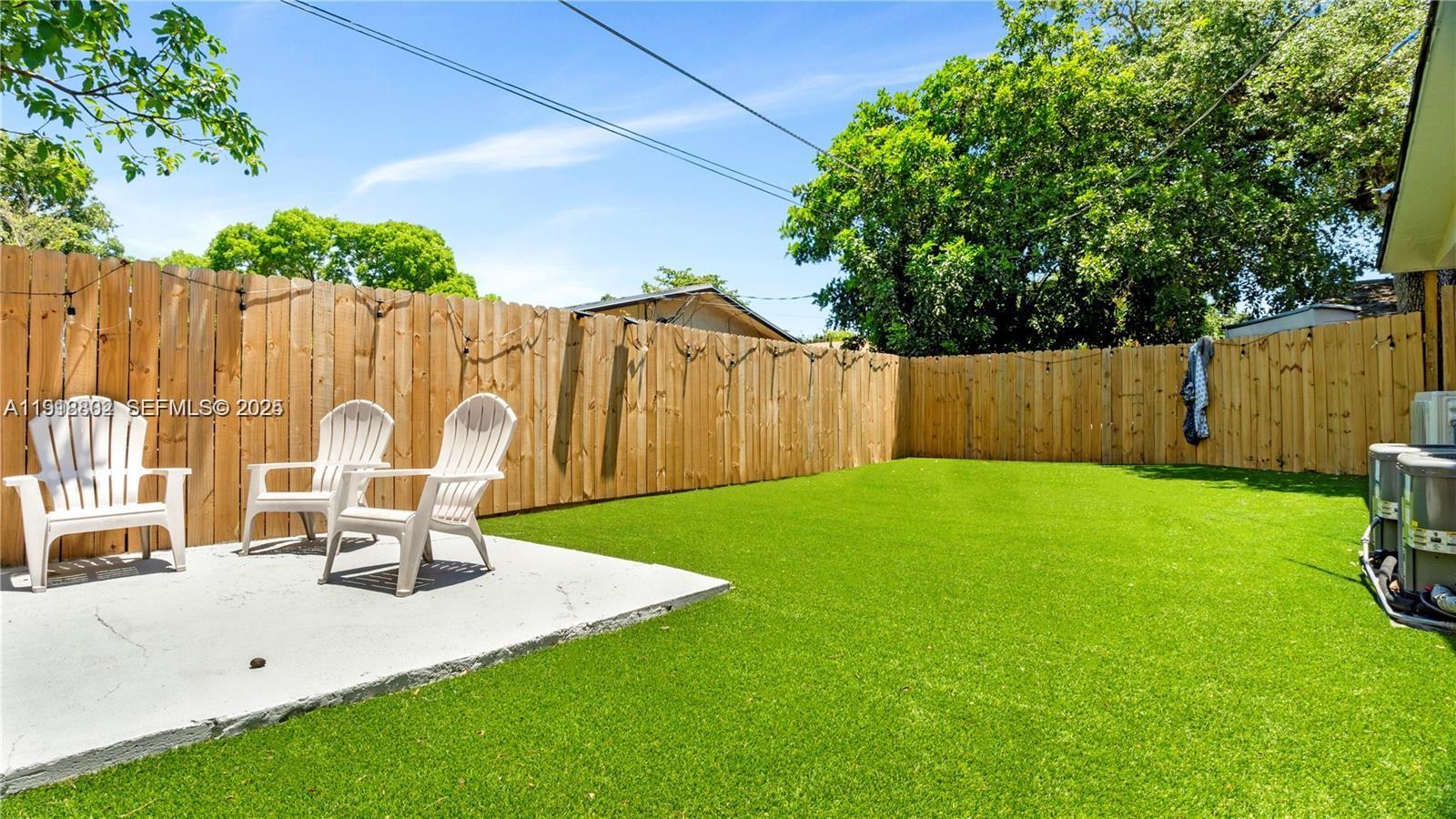 32 Southwest 9th Street, Unit 3 Hallandale Beach, FL 33009 - Photo 13 of 13 a view of a backyard with a table and chairs