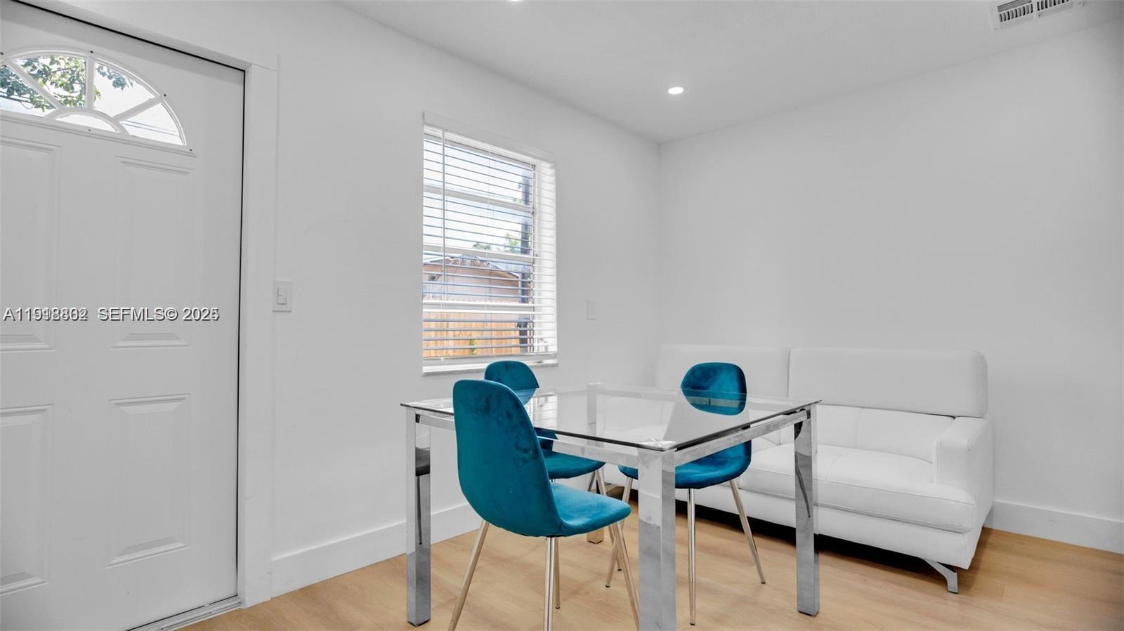 32 Southwest 9th Street, Unit 3 Hallandale Beach, FL 33009 - Photo 5 of 13 a living room with furniture and a window