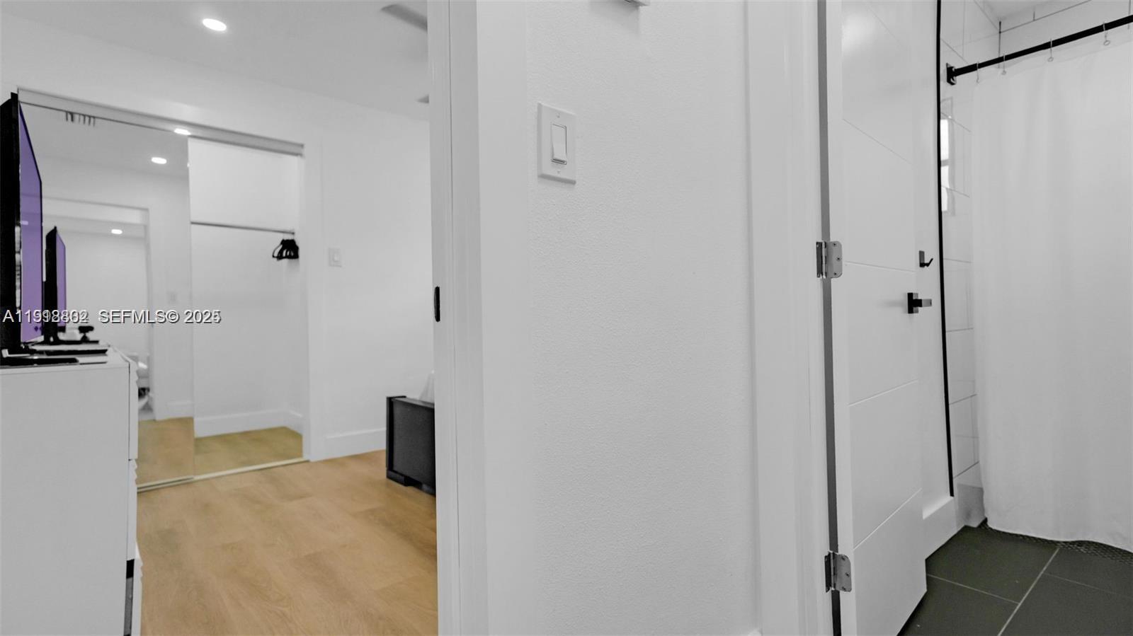 32 Southwest 9th Street, Unit 3 Hallandale Beach, FL 33009 - Photo 6 of 13 a view of a livingroom with wooden floor