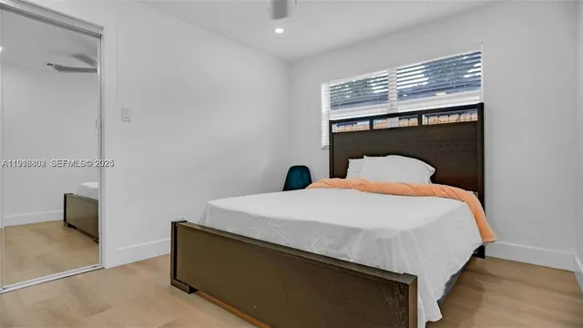 a bedroom with a bed and a painting on the wall