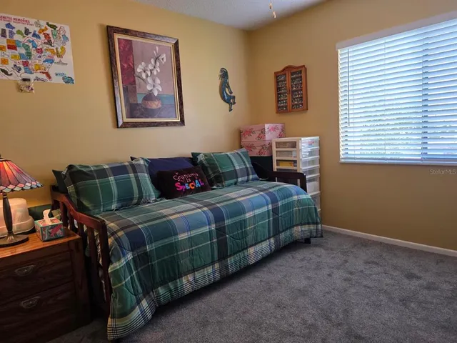 a bedroom with bed and a window
