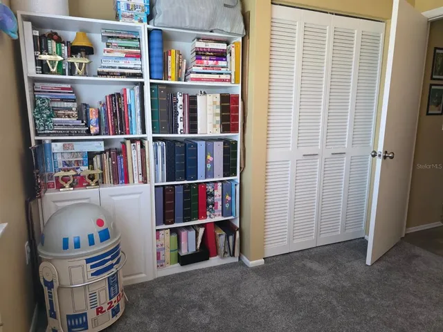 a room with a book shelf and a shelf