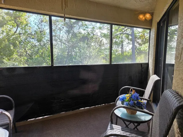 a table chair sitting in a bedroom next to a window
