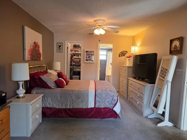 a bedroom with furniture and a flat screen tv