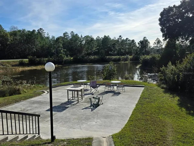 a view of a lake with a table and chairs