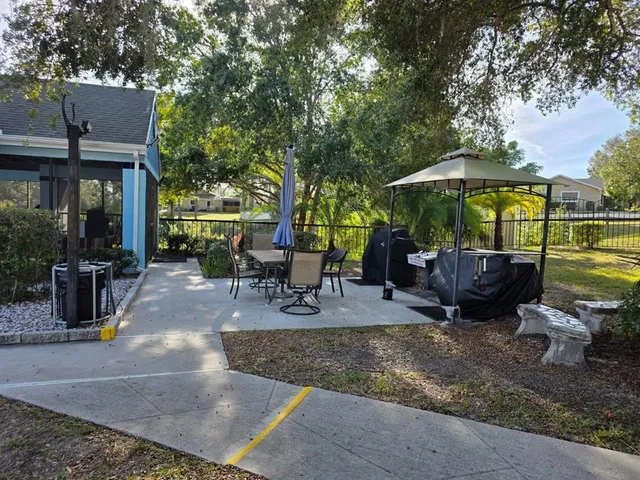 a view of a backyard with sitting area and furniture