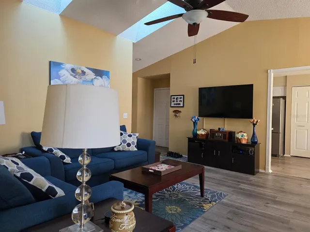 a living room with furniture and a flat screen tv