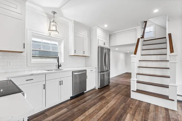 a kitchen with a sink stove and cabinets