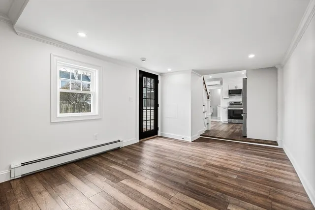 a view of empty room with wooden floor