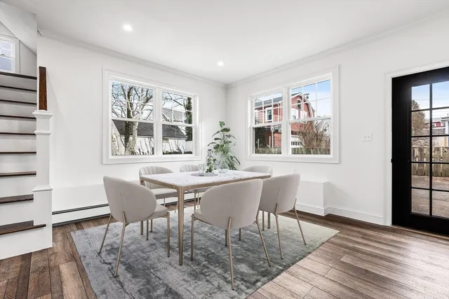 a living room with furniture a flat screen tv and a large window