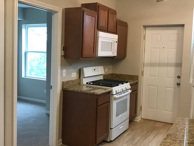 a kitchen with stainless steel appliances granite countertop a stove and a refrigerator