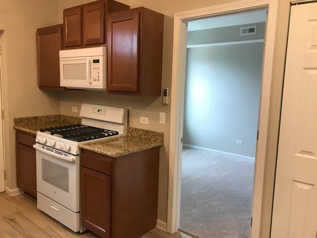 a kitchen with a stove and a microwave