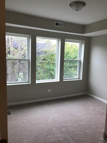 a view of room with window and hardwood floor