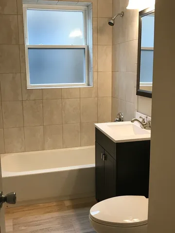 a bathroom with a sink mirror vanity and toilet
