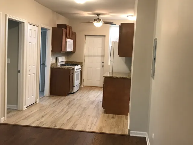 a kitchen with stainless steel appliances granite countertop a refrigerator and a sink