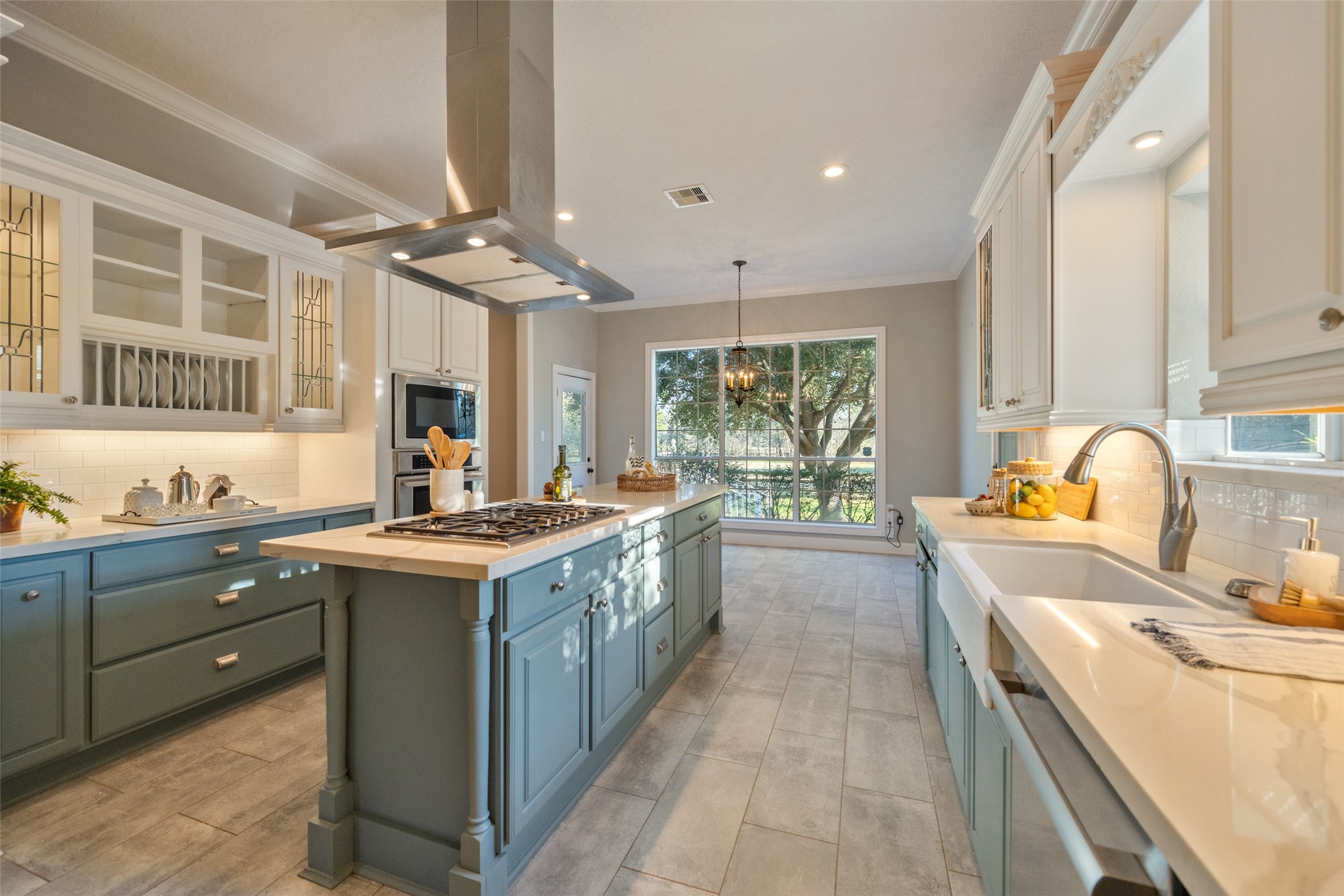 36003 Post Oak Circle Magnolia, TX 77355 - Photo 3 of 50 a kitchen with a stove a sink a center island and a window