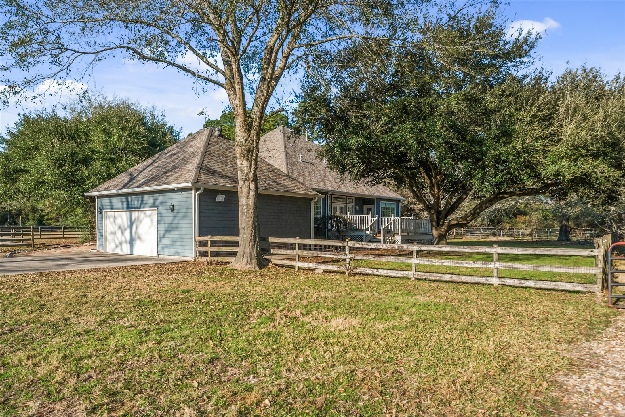 36003 Post Oak Circle Magnolia, TX 77355 - Photo 33 of 50 a view of a house with a large tree and a yard