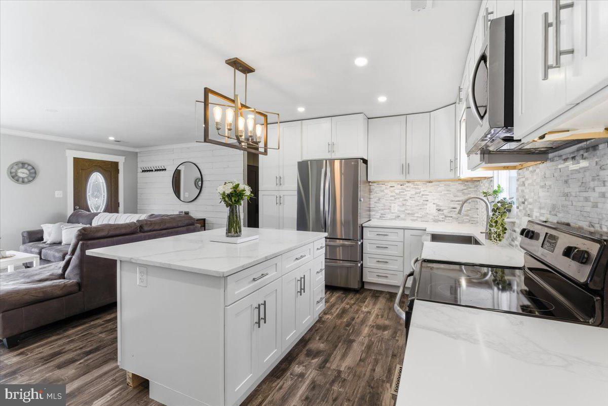 103 North Cypress Road Sterling, VA 20164 - Photo 12 of 31 Designer lighting and tile backsplash
