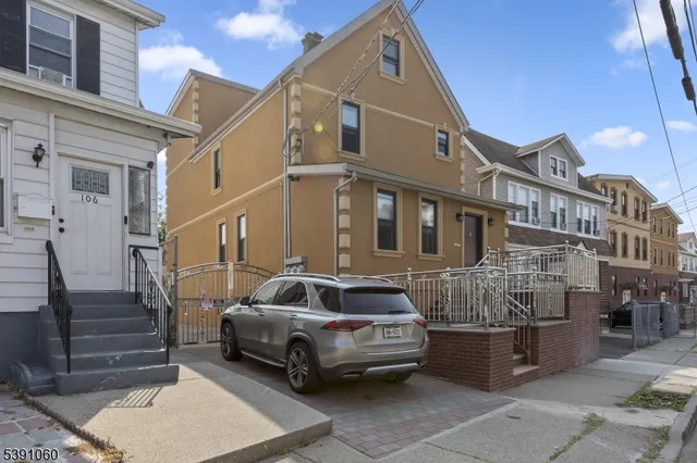 a car parked in front of a brick house