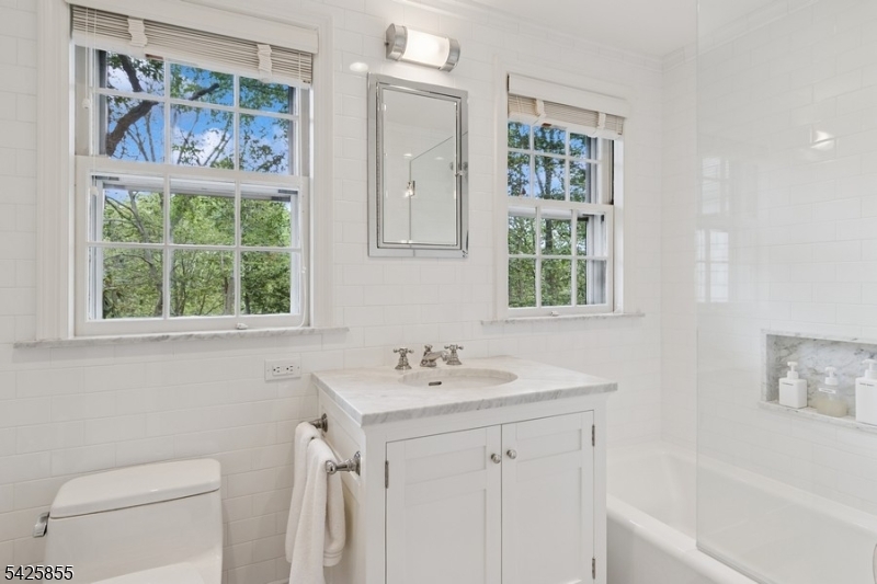 21 Hardwell Road Short Hills, NJ 07078 - Photo 34 of 50 a bathroom with a sink a toilet a window and a shower